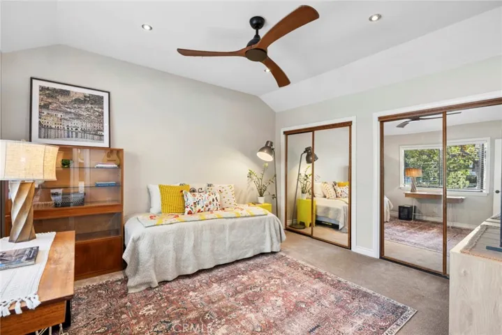 Spacious secondary ensuite bedroom with vaulted ceilings, abundant natural light, and generous closet space.