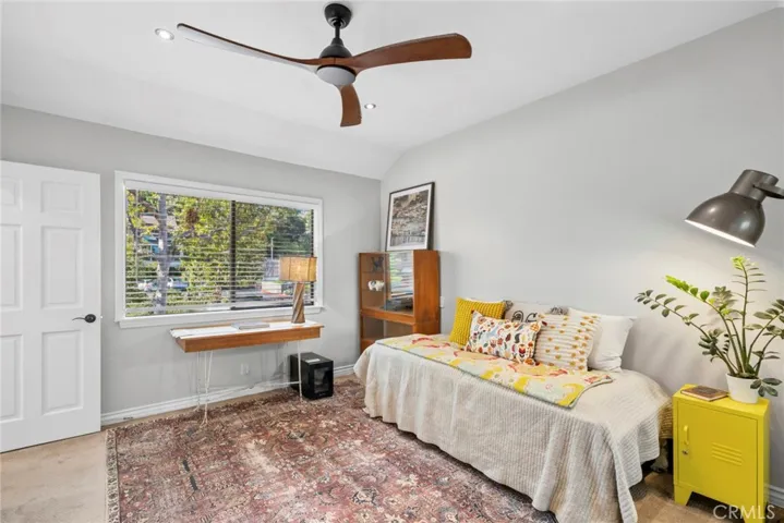 High ceilings and a large picture window overlooking the trees give this secondary primary an open, airy feel filled with natural light.