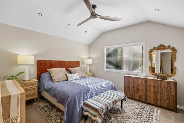 Generous primary suite with vaulted ceilings, peaceful treetop views, and abundant natural light.