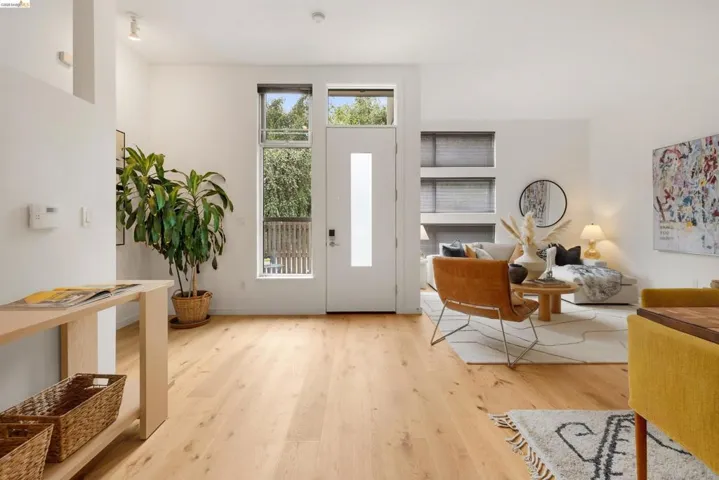 Spacious open-concept living area featuring light wood-finish flooring