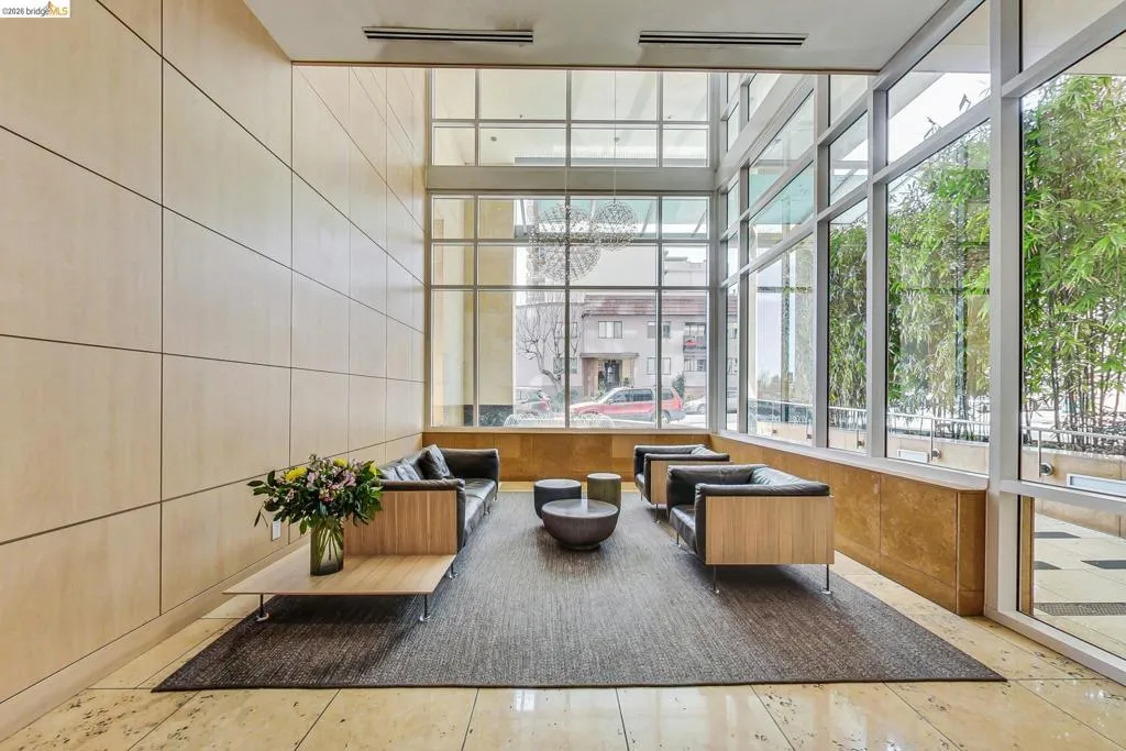 Double-height windows with a grid pattern frame the exterior, complemented by a light wood-paneled wall