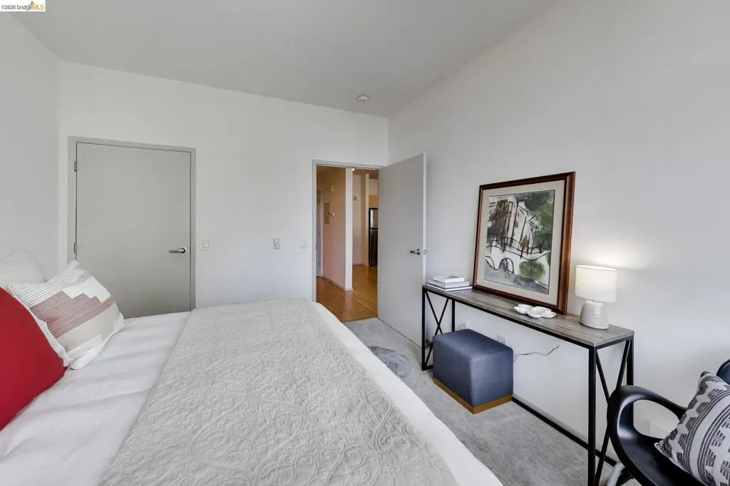 Interior room featuring light-colored walls and a neutral-toned door with brushed nickel hardware