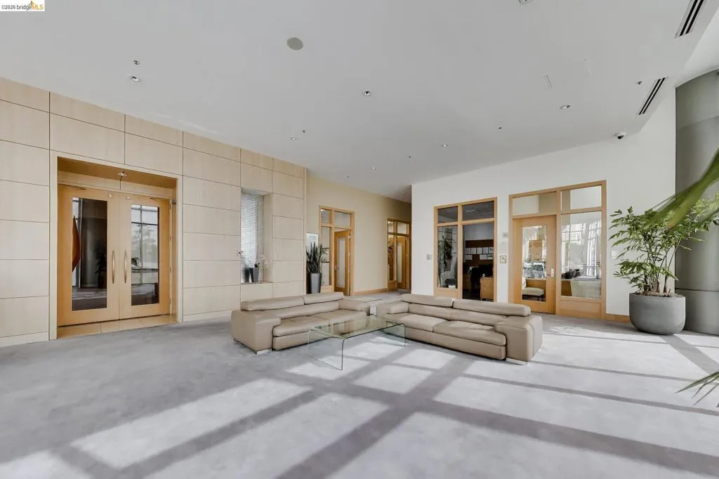 Light-toned wood paneled walls complement a broad gray floor