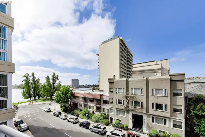 Elevated cityscape with a prominent body of water, bordered by a tree-lined street