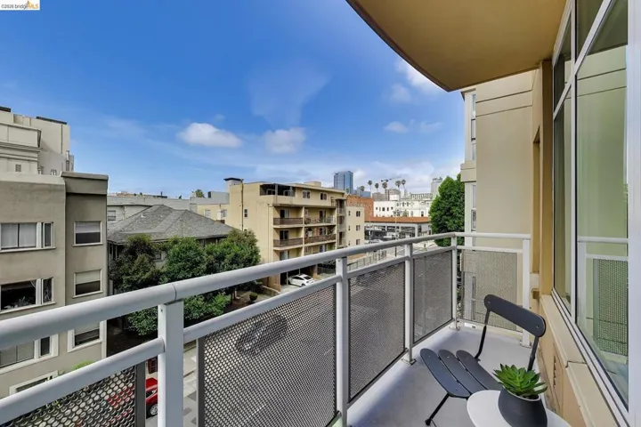 Private balcony featuring metal railing with mesh infill panels