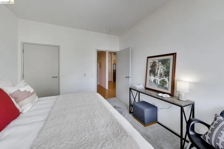 Interior room featuring light-colored walls and a neutral-toned door with brushed nickel hardware