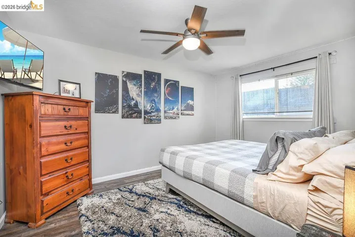 Wood-finish flooring throughout, complemented by a ceiling fan with integrated lighting