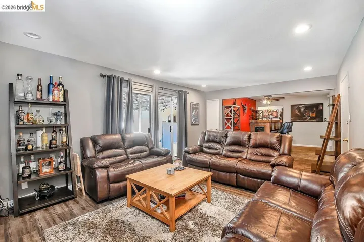 Spacious living area featuring wood-finish flooring, recessed lighting, and a neutral wall palette
