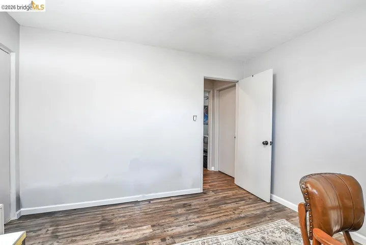 Interior room featuring wood-finish flooring and light gray walls