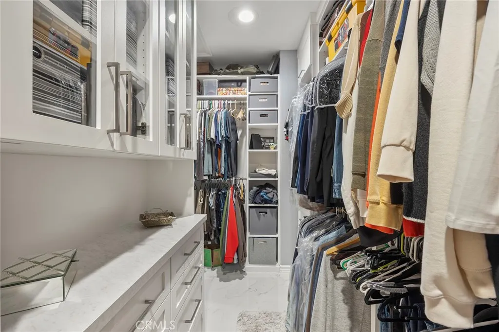 Primary bedroom closet with built-ins.