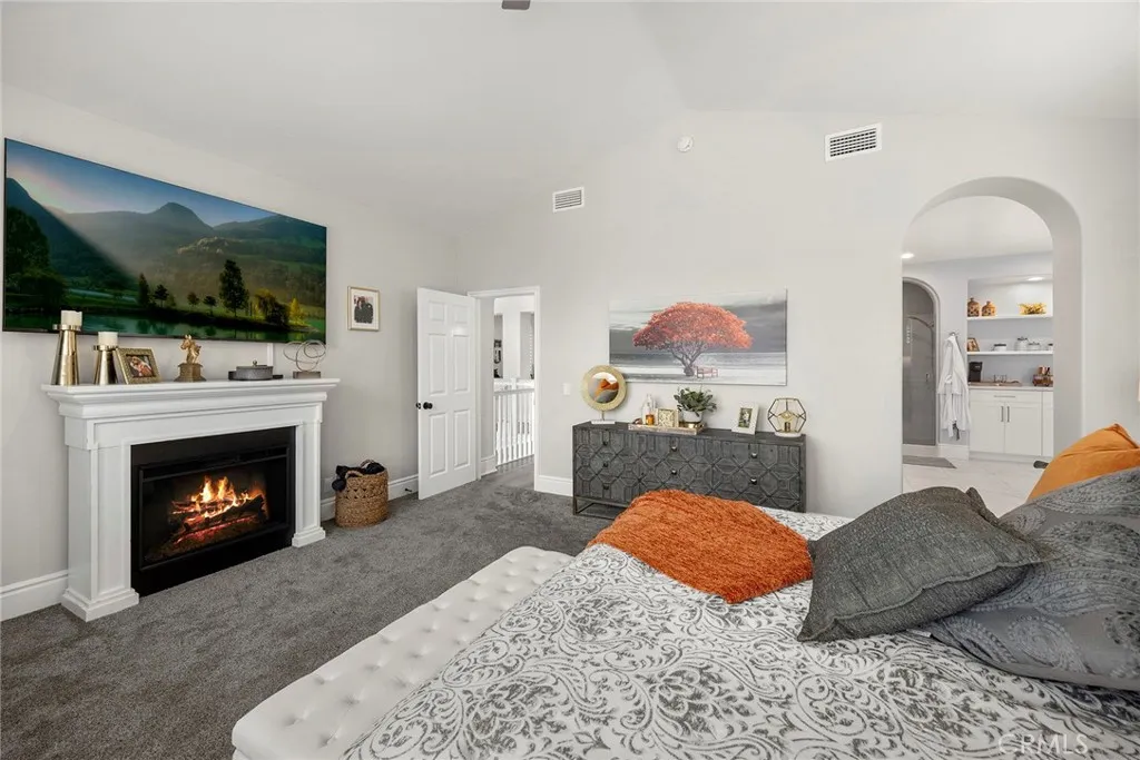 Primary bedroom with fireplace. (Digitally enhanced fire).