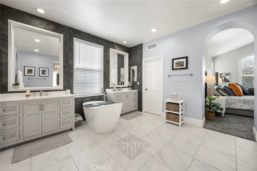 Primary bathroom with tile flooring.