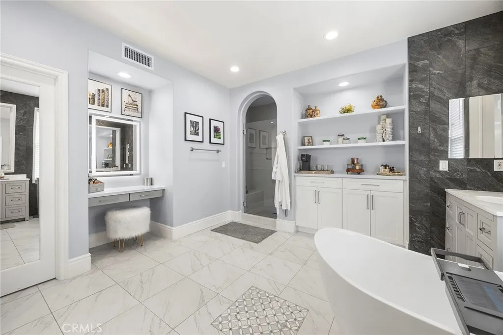 Luxury primary bathroom with custom vanity lighting.