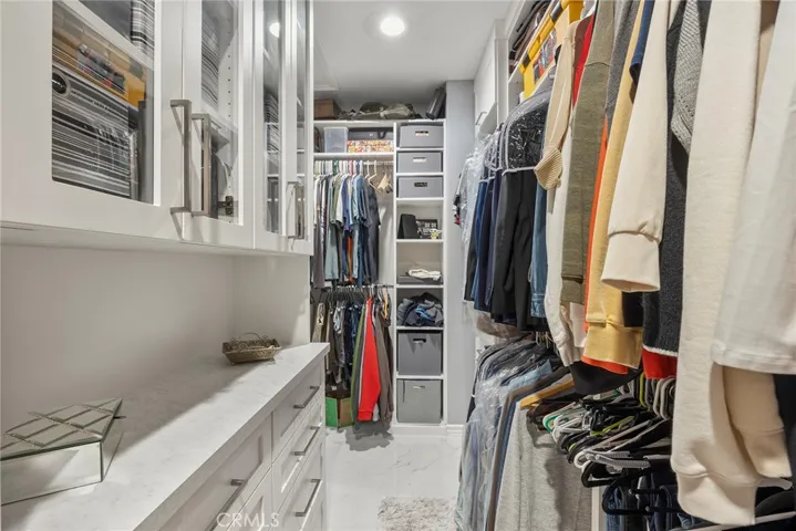 Primary bedroom closet with built-ins.