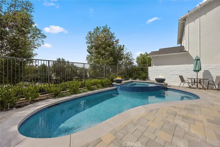 Recently updated pool and spa with pebble tech coating and fire bowls.  (Digitally enhanced fire).