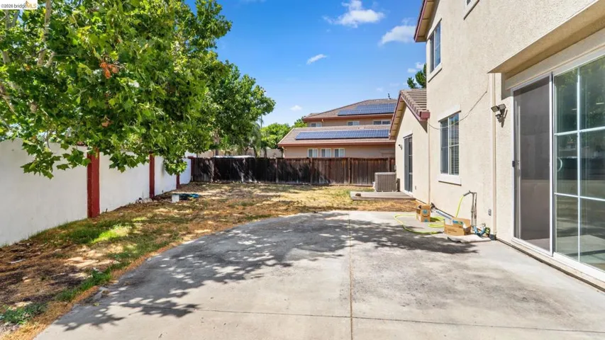 Expansive concrete patio with direct access via sliding glass doors