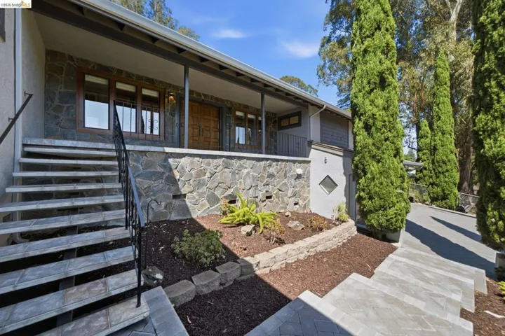 Stone veneer facade featuring a covered porch entry