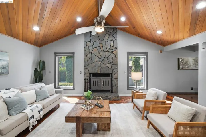 Vaulted wood-paneled ceiling with recessed lighting and a ceiling fan