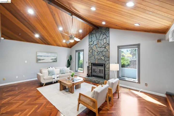 Vaulted wood-paneled ceiling with recessed lighting and a ceiling fan
