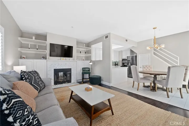 Spacious living area with gas fireplace and herringbone marble façade.