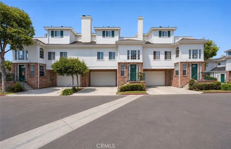French-style curb appeal with classic symmetry and arched brickwork.