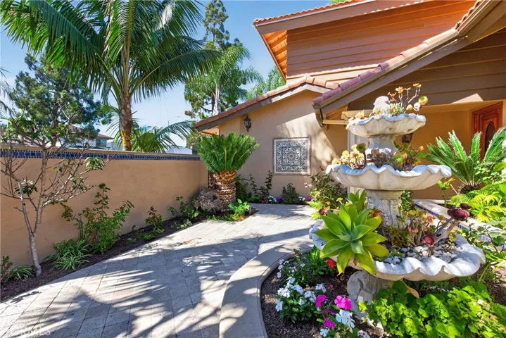 Gorgeous Courtyard entry with 3 level fountain and vibrant plants and flowers throughout.