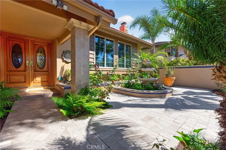 Gorgeous Courtyard entry with 3 level fountain and vibrant plants and flowers throughout.