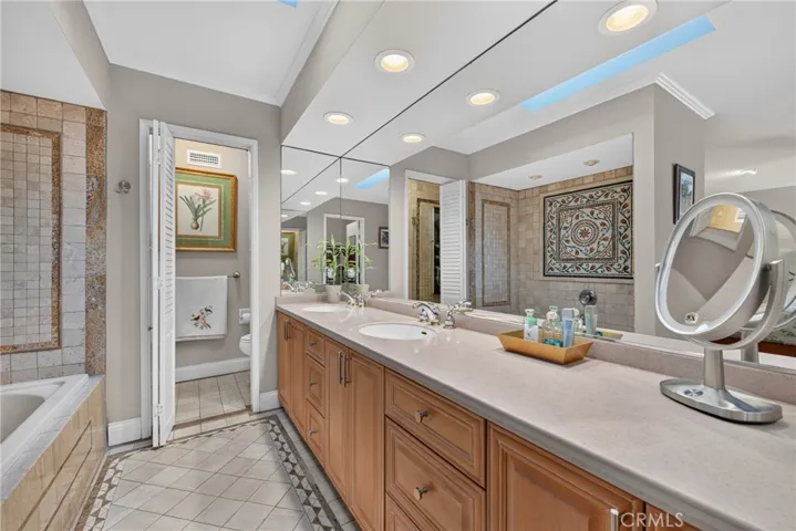 Master suite has walk in closet, spa tub and separate mosaic tiled shower with massage water features.