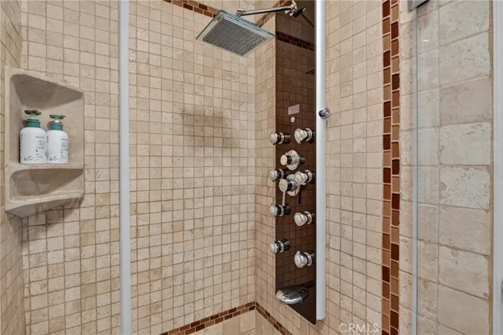 Master suite has walk in closet, spa tub and separate mosaic tiled shower with massage water features.