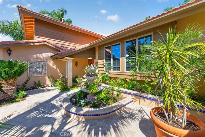 Gorgeous Courtyard entry with 3 level fountain and vibrant plants and flowers throughout.