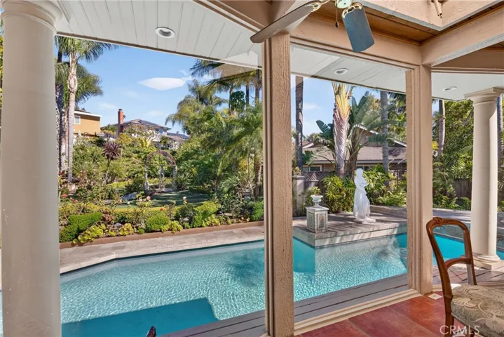 Expanded sunroom/breakfast area overlooking oversized pool & and huge back yard garden organic sanctuary/refuge filled exquisite, lush and vibrant plants and flowers.