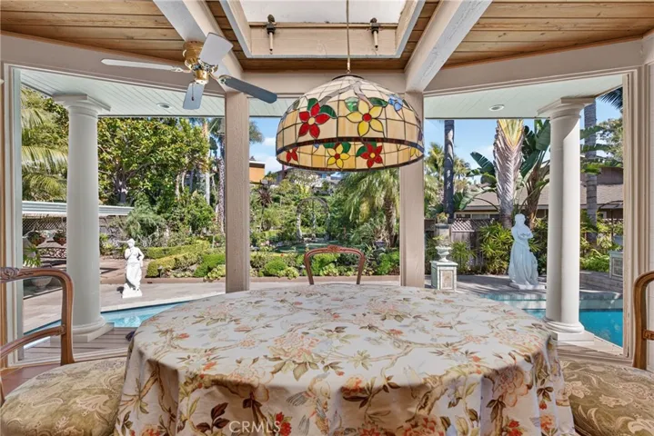Expanded sunroom/breakfast area overlooking oversized pool & and huge back yard garden organic sanctuary/refuge filled exquisite, lush and vibrant plants and flowers.