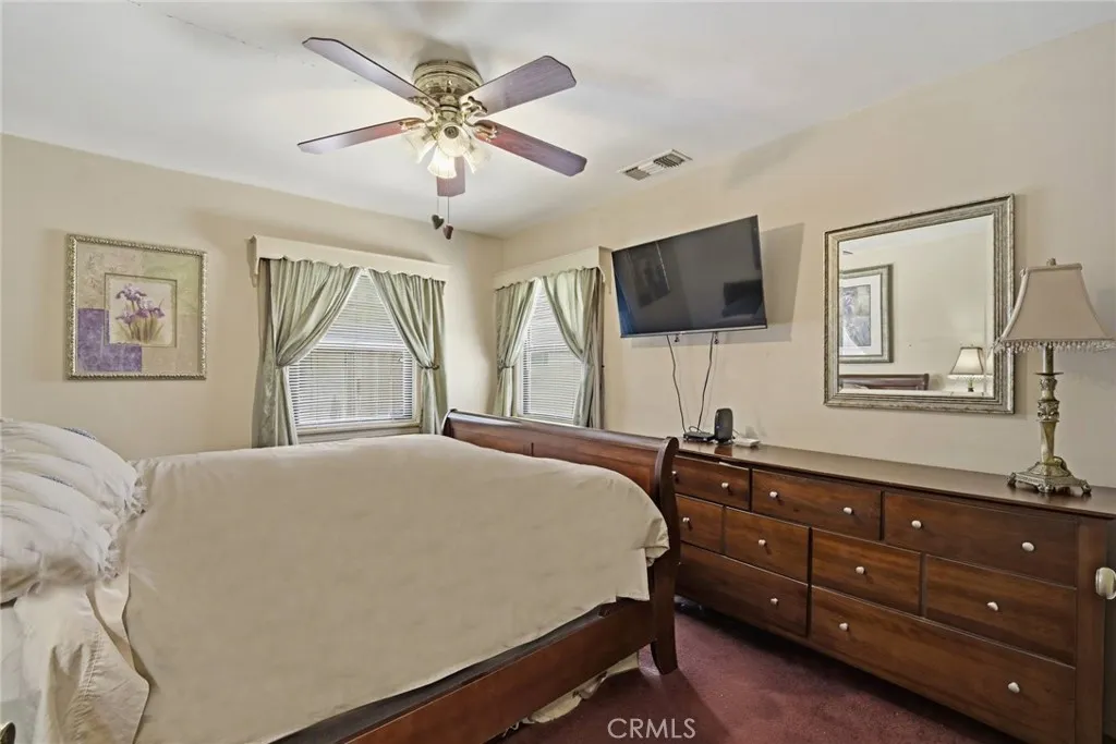 Primary Bedroom with corner widows and view of backyard