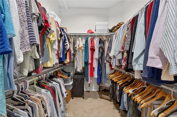 Primary bedroom walk in closet