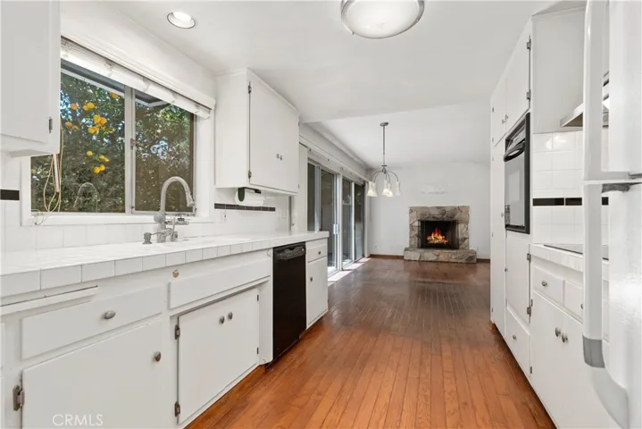 Galley kitchen between living room and family room.