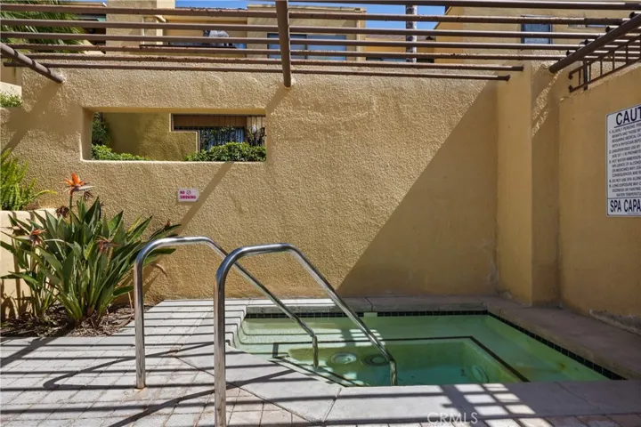 Jacuzzi in pool area to the right of complex