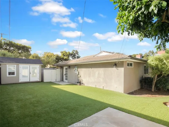 Grass sprawling lawn with outdoor storage shed/office