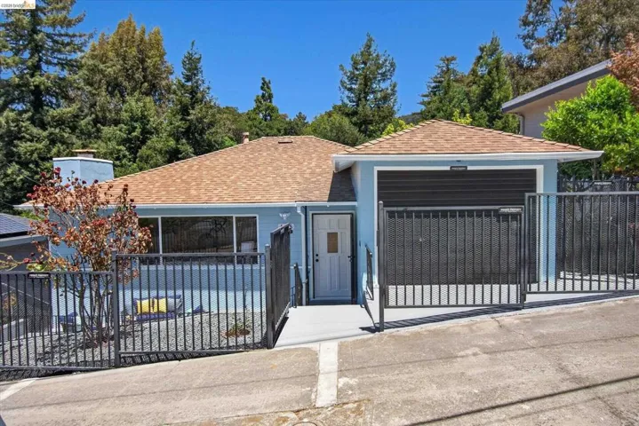 Light blue exterior with a brown shingle roof