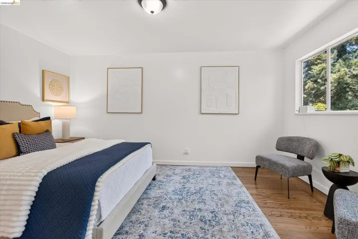 Bright room featuring wood-finish flooring and white walls