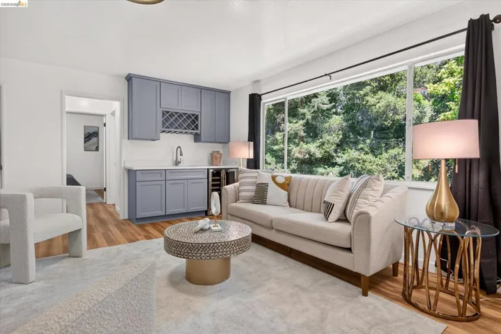 Living area featuring a built-in wet bar with gray cabinetry, a wine rack, and a beverage refrigerator