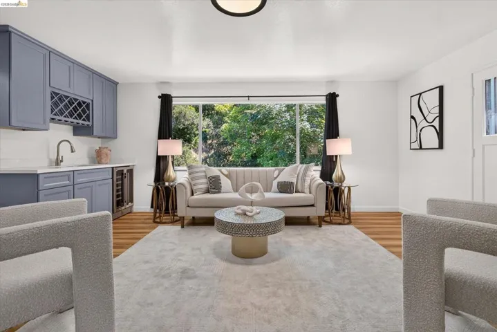 Open concept living space featuring wood-finish flooring and a built-in wet bar with a wine refrigerator and dedicated wine rack