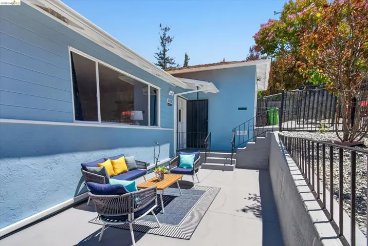Exterior patio featuring a concrete surface and black metal railings