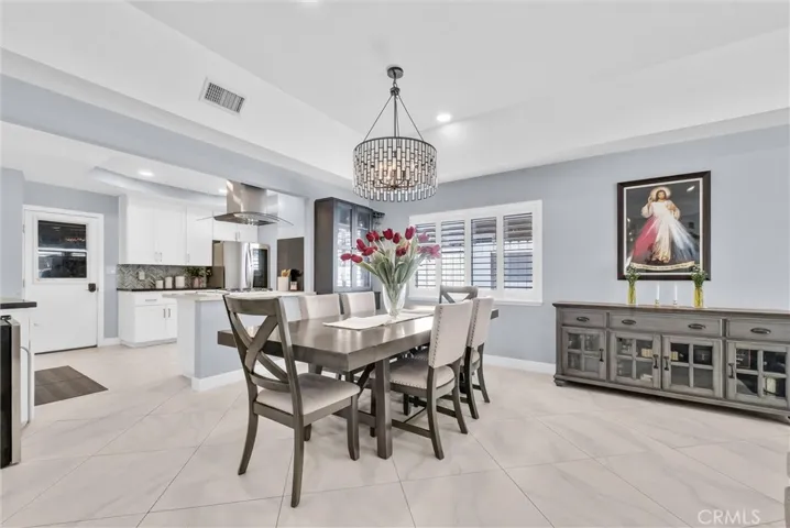 An elegant chandelier adorns the dining area.
