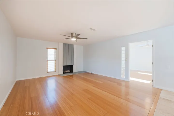 The Living Room features Bamboo Flooring, a Cozy Fireplace and opens into the Bonus Room/Flex Space.