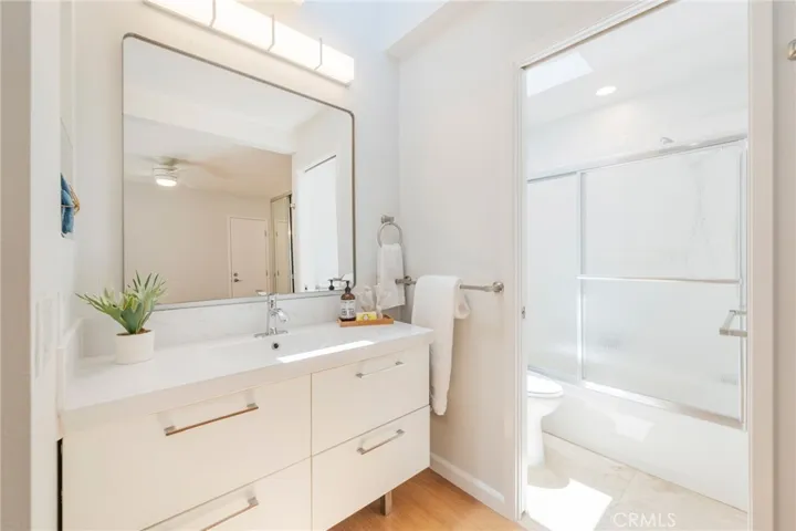 The Secondary Bedrooms En-Suite Bathroom offers a Bathtub/Shower with New Sliding Glass Doors and Fixtures.