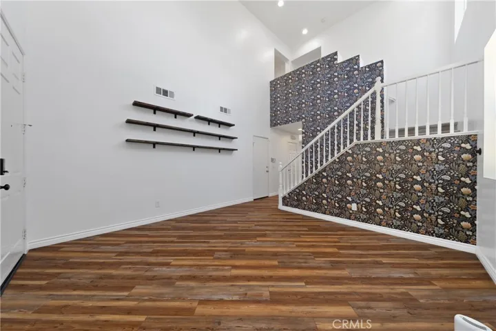 Elegant Entryway Showcasing Custom Accent Wall And Luxury Vinyl Flooring