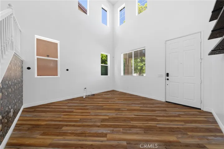 Bright Formal Living Room Featuring Soaring Ceilings And Abundant Natural Light