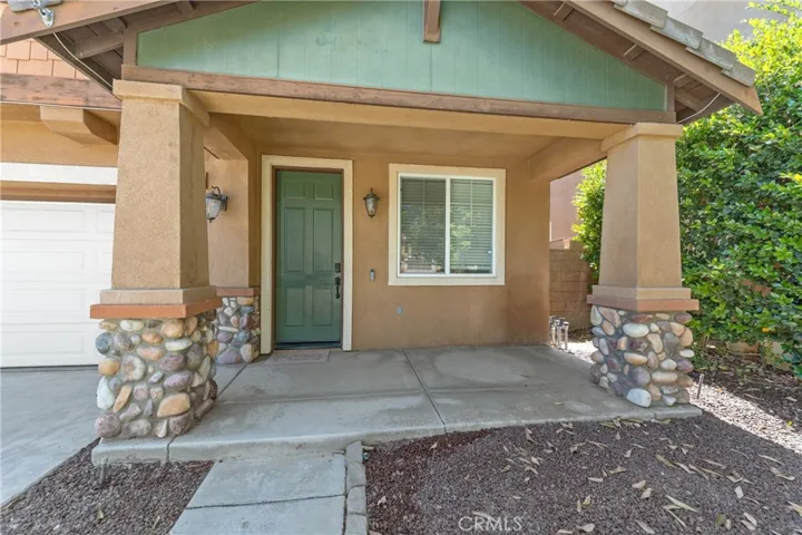 Welcoming Covered Front Porch With Stone Accents