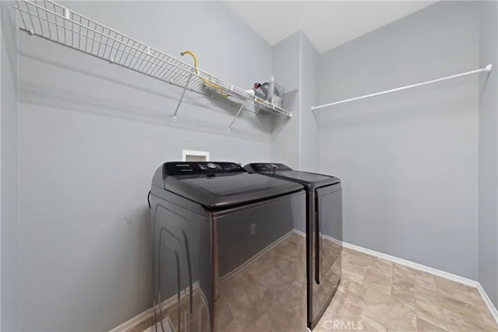 Convenient Indoor Laundry Room With Built-In Storage Shelving