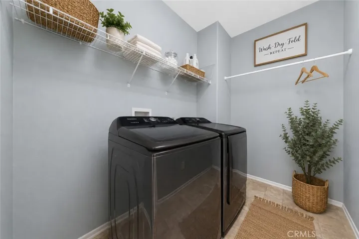 Convenient Indoor Laundry Room With Built-In Storage Shelving - Digitally Staged